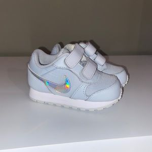 Nike. Light grey with shades of pink and white glow on the nike sign. Size 4